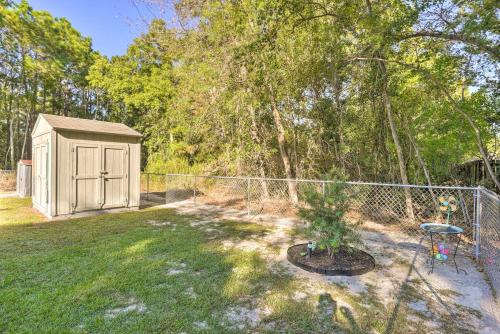 a backyard with a fence and a small shed at Cloud 9 On The Coast Less Than 1 Mi to Beach! in Waveland