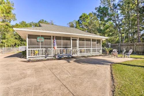 a house with a porch with chairs and a fence at Cloud 9 On The Coast Less Than 1 Mi to Beach! in Waveland