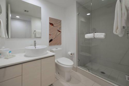 a bathroom with a toilet and a sink and a shower at Wonderful Studio @Beachwalk with Great Views&Pool in Hallandale Beach