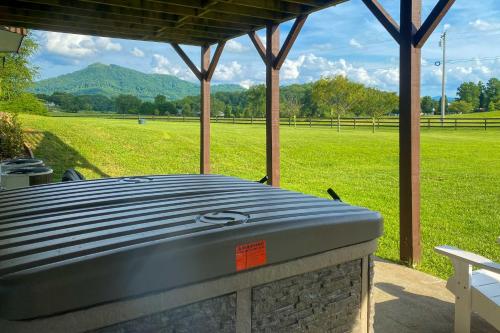 a picnic table with a view of a field at Beautiful Hiawassee Home with Mountain Views! in Hiawassee