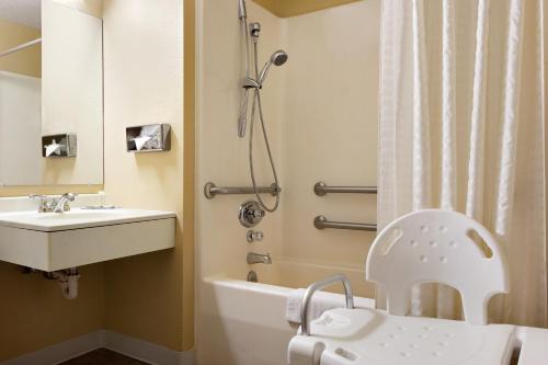 a bathroom with a sink and a toilet and a shower at Super 8 by Wyndham Marion in Marion