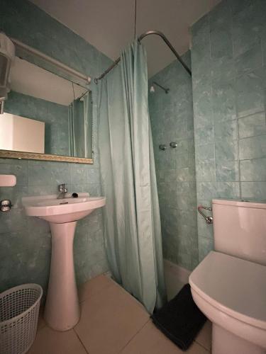 a bathroom with a sink and a toilet and a shower at P&R hostals Maria Rosa in Tossa de Mar
