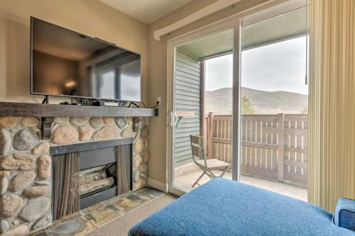 a bedroom with a fireplace and a large window at Park City Condo with View - Walk to Shops and Dining in Park City