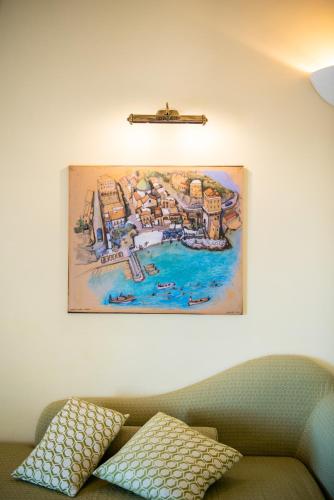 a painting hanging on a wall above a couch at Hotel Margherita in Praiano