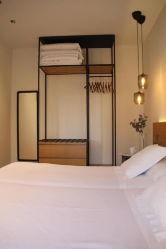 a bedroom with a white bed and a bunk bed at Hotel Boutique Astorga in Valladolid