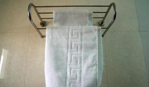 2 asciugamani su un portasciugamani in bagno di Dialali Hôtel Nouakchott a Nouakchott