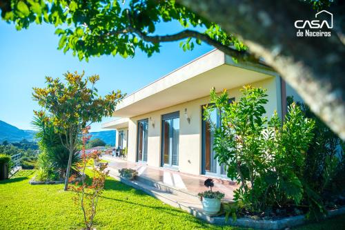 a house with a view of the yard at Casa de Naceiros - Ponte de Lima in Viana do Castelo