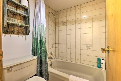 a bathroom with a tub and a toilet and a sink at Iron Horse Studio with Resort Amenities Walk to WP! in Winter Park