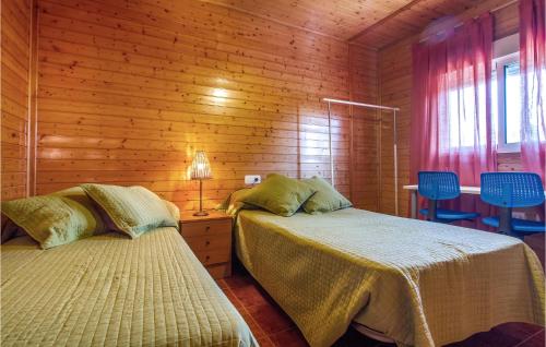 a bedroom with two beds in a wooden cabin at Awesome Home In Molina De Segura With Kitchen in Molina de Segura