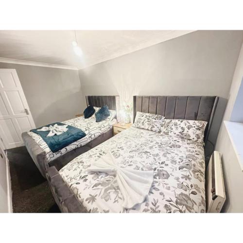 a bedroom with two beds in a small room at Cosy & Spacious Lodge Dartford in Kent