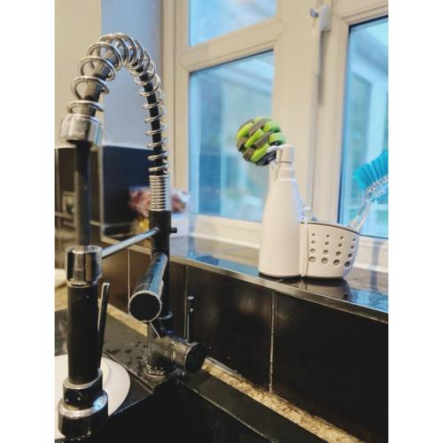 a kitchen sink with a faucet and a counter top at Cosy & Spacious Lodge Dartford in Kent