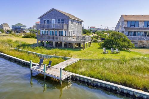a house on the water with a dock at Sound FX 437 in Avon