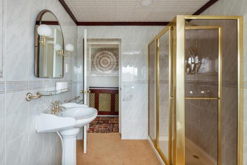 a bathroom with a sink and a shower at Beautiful 'Mayfield' Villa with private pool! in Manchester