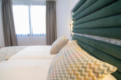 a hotel room with a bed and a window at Laguna Home & Suites in La Laguna