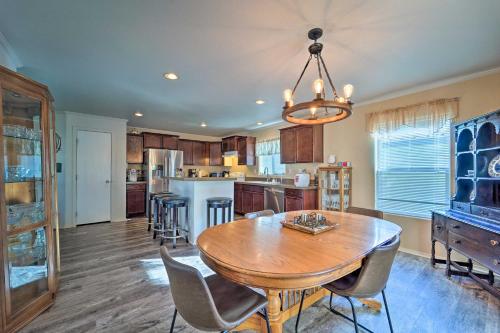 a dining room with a table and a kitchen at Peaceful Portales Escape with Patio and Grill! in Portales
