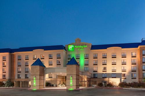 a hotel with a green clock on the front of it at Holiday Inn Hotel & Suites Council Bluffs by IHG in Council Bluffs