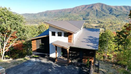 an aerial view of a house with mountains in the background at Stunning View Luxury Heated Pool Arcade Theater 12 in Sevierville