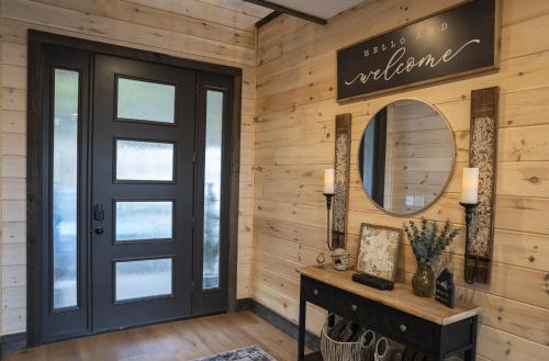 a wooden hallway with a black door and a mirror at Stunning View Luxury Heated Pool Arcade Theater 12 in Sevierville