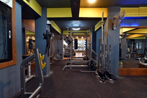 a gym with several treadmills and machines at Hotel Lilac Doors in Patna