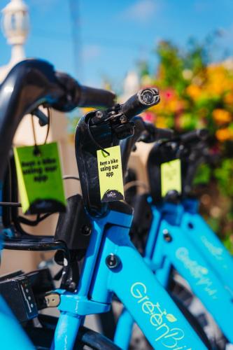 a row of blue bikes with tags on them at Hotel RH Boutique Aruba in Oranjestad