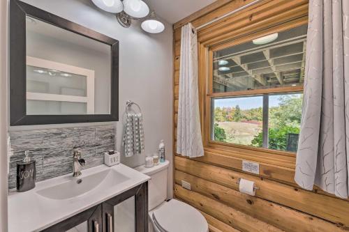a bathroom with a sink and a toilet and a window at Cozy Wisconsin Studio, 11 Mi to Lake Geneva! in Burlington
