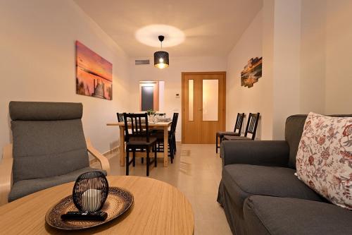 a living room with a couch and a table at Alojamiento Alcantara in Alora