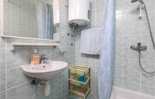 a bathroom with a sink and a mirror and a shower at Gorgeous Apartment In Stara Novalja With Kitchenette in Stara Novalja