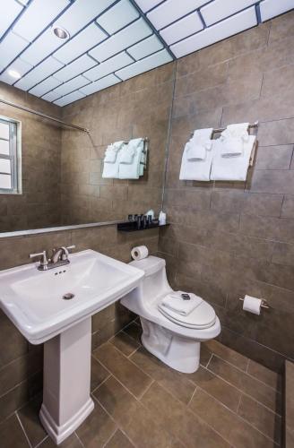 a bathroom with a sink and a toilet at Kent Hotel in Miami Beach