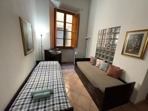 a living room with two beds and a window at Artemisia in Pisa