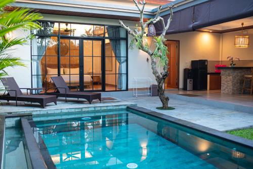 a swimming pool in the backyard of a house at Sawitri Anandhita Luxury Villas in Ubud