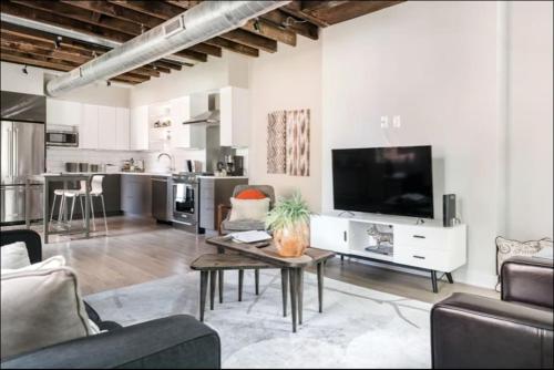 a living room with a couch and a tv and a table at This property is unlisted in Cincinnati