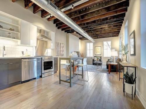 a large kitchen and living room with wooden ceilings at RUSTIC BEAUTY/ Walk to TQL Stadium/ Market/ in Cincinnati