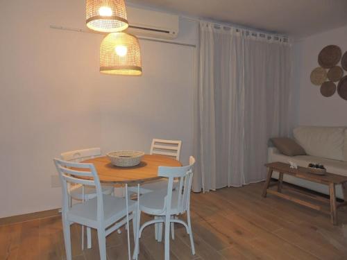 y sala de estar con mesa de comedor y sillas. en Suite La Savina Formentera con vistas al mar, en La Savina