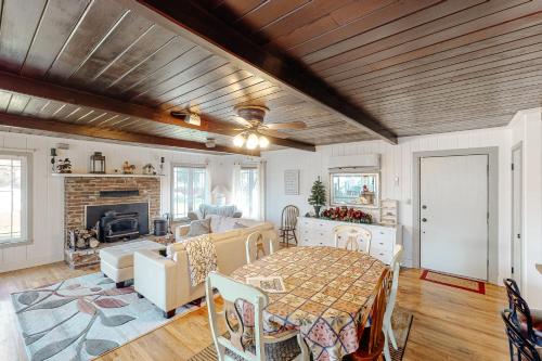 a living room with a table and a fireplace at Bear Den in Oakhurst
