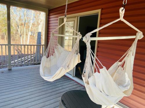 two hammocks hanging on a porch of a house at Swan Lake Resort in Galloway