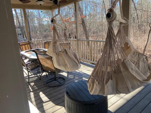 a porch with two hanging bags and a table at Swan Lake Resort in Galloway