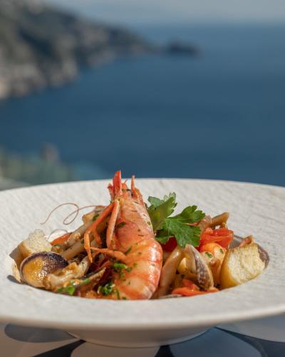 a plate of food with a shrimp and vegetables at Hotel Margherita in Praiano