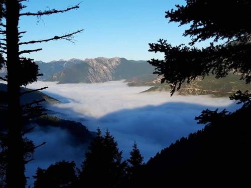 a view of a sea of clouds in the mountains at Omalia Village in Áno Khóra