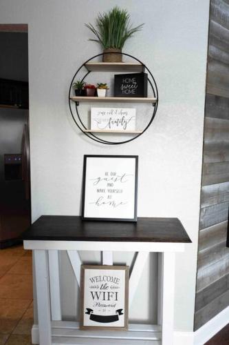a table with a mirror and a plant on it at Modern 3BR Home, Saltwater Pool, Fenced Yard in Spring Hill
