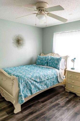 a bedroom with a bed and a ceiling fan at Modern 3BR Home, Saltwater Pool, Fenced Yard in Spring Hill
