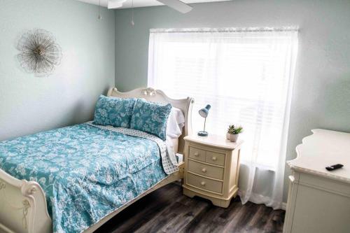 a small bedroom with a bed and a window at Modern 3BR Home, Saltwater Pool, Fenced Yard in Spring Hill