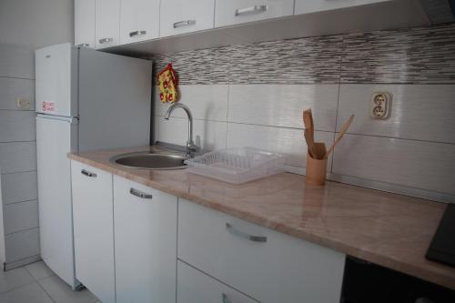 a kitchen with a sink and a counter top at Cavleski apartment in Prilep