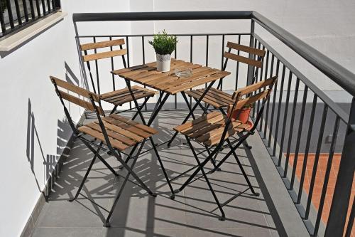 a wooden table and chairs on a balcony at Alojamiento Alcantara in Alora