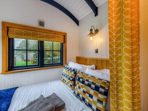 a bedroom with two beds and a window at The Dalesbred Hut - Uk40150 in Rathmell