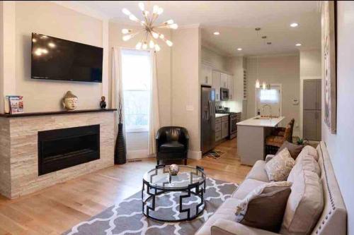 a living room with a couch and a fireplace at Modern/ parking/Eden Park/near Downtown/ FCC in Cincinnati