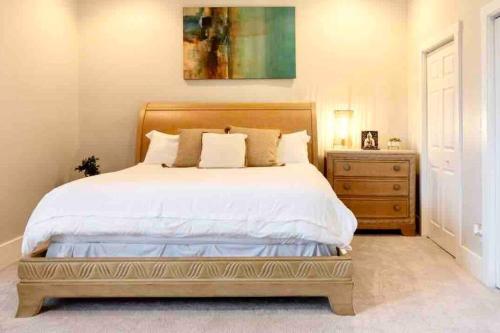 a bedroom with a large bed and a dresser at Modern/ parking/Eden Park/near Downtown/ FCC in Cincinnati