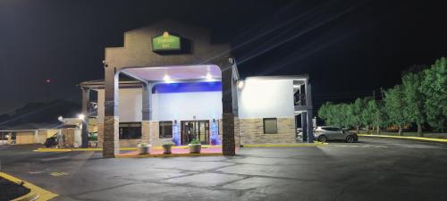 a gas station at night with a sign on it at Jameson Inn Conyers in Conyers