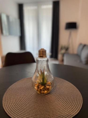 a glass jar with a plant in it on a table at Residence 33 in Sarajevo