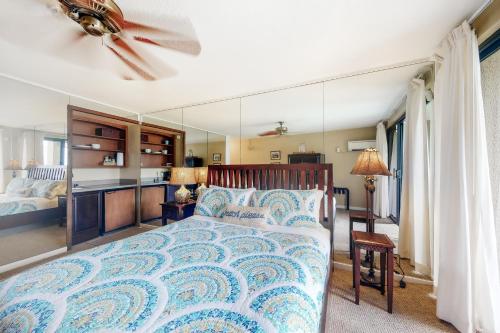 a bedroom with a bed and a large mirror at Hanalei Bay Resort 9204 in Princeville