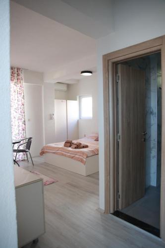 a bedroom with a bed and a sliding glass door at Cavleski rooms in Prilep
